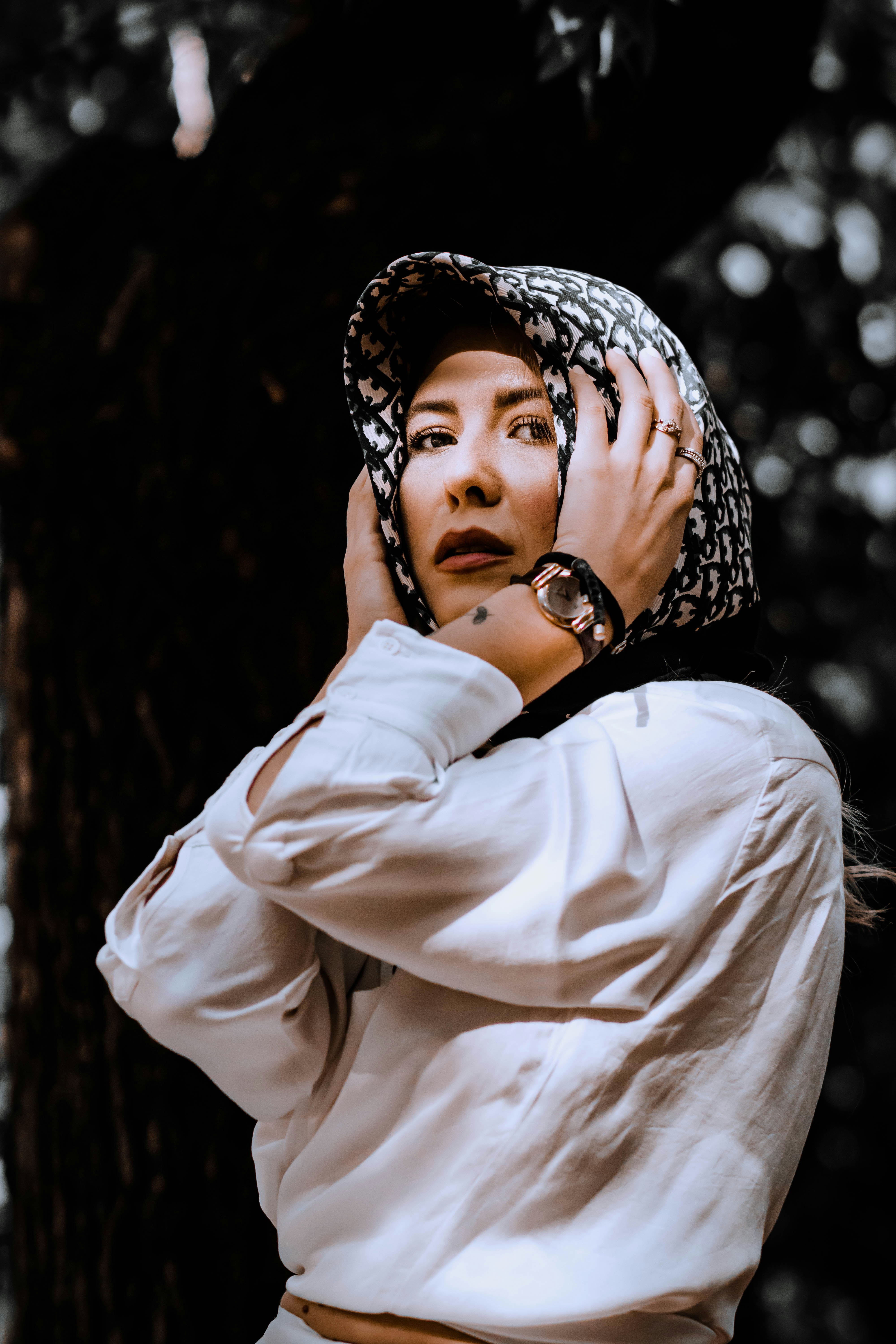 woman in white long sleeve shirt wearing black and white hijab